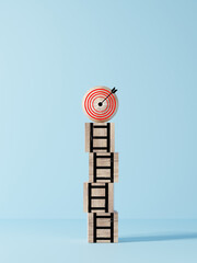 Dartboard with arrow on the top of ladders step for target and goal concept.