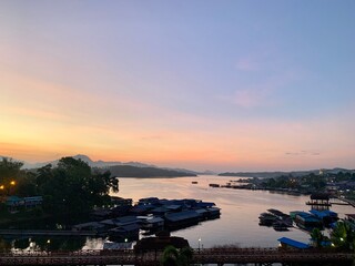 The bridge is embraced by verdant mountain ranges, surrounded by plants of diverse species, and covered by a thin layer of fog. The dazzling bridge that reflects the charm of local people's way of lif