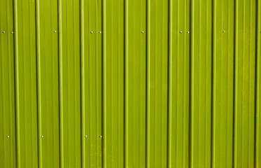 yellow metal decking. new, modern Sheets of yellow corrugated iron.  Texture of green metal fence,...
