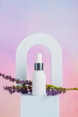 Cosmetic product in tube, bottle, lotion or serum and dried lavender on colorful background. 