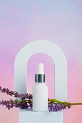 Cosmetic product in tube, bottle, lotion or serum and dried lavender on colorful background. 