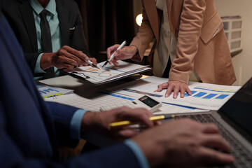 Group of modern business people pointing to data from graph papers Chart discussing in the conference room on Report, Sales, Target, Marketing, Concept.