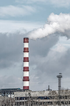 Factory chimney on a cloudy winter day