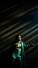 Portrait of a young Asian woman posing in the subway near the stairs. 