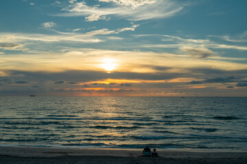Fototapeta premium Dramatic sunset sky. sea. Calm sea with sunset sky through the clouds over. Meditation ocean and sky background. Tranquil seascape. Horizon over the sunset sea water. Calm sea with sunset sky.