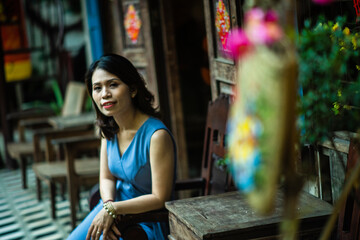 Woman wearing trendy clothes, well-proportioned figure of 35 years old, beautiful colors in Sai Gon's Tet season