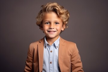 Portrait of a cute little boy with blond curly hair. Studio shot.