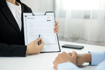 Business people hold a resume and talk to job applicants for job interviews about careers and Their...