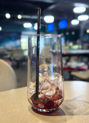 Ice in a glass on a table in a cafe