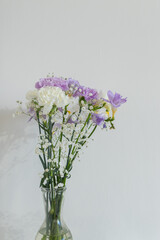 Bouquet of pale purple and white carnations close up. Beautiful blooming lilac flowers. Floral photo with copy space