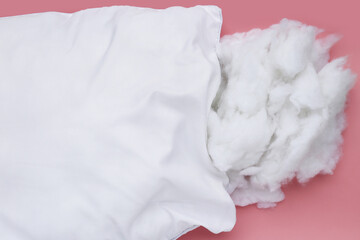 White pillow with polyester stable fiber on pink background.