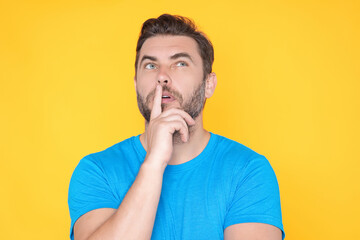 Portrait of thoughtful guy making choice. Handsome man thinking on isolated studio background. Man...