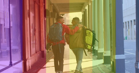 Fototapeta na wymiar Image of back view of gay couple walking on street