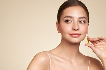 Vitamins. Close Up Of Happy Beautiful Girl With Pill With Cod Liver Oil Omega-3. Nutrition. Vitamin...