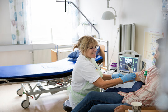 Female doctor doing doppler ultrasound test evaluation of blood vessels on patient
