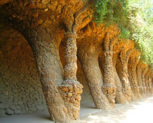 Arcade of masonry stone columns in Park Guell Barcelona of Gaudi modernism by Antoni Gaudi in...