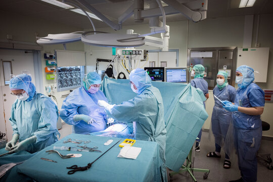 Surgeons and nurses operating patient in operation theater at hospital