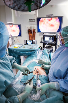 Doctor and nurses doing surgery of patient with medical equipment in operating theater