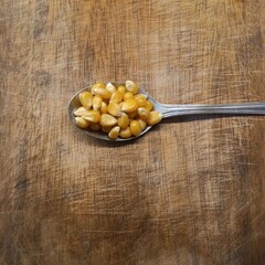 corn on a wooden spoon