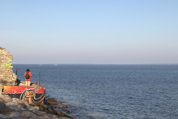 A man standing next to the sea