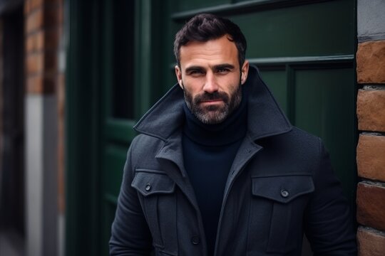 Portrait of a handsome man in a black coat. Men's beauty, fashion.
