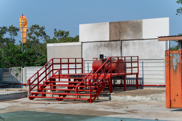 The red steel stage has a ladder and a fire-breathing device. Used for firefighting training
