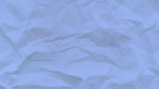 Animation of blue creased paper over shapes