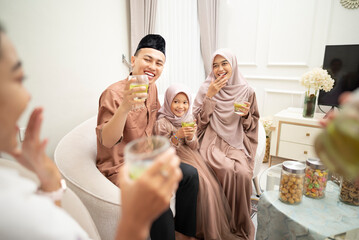 Portrait of two Muslim families celebrating Idul Fitri or Eid al Fitr