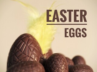 Chocolate Easter eggs postcard with text and yellow feather