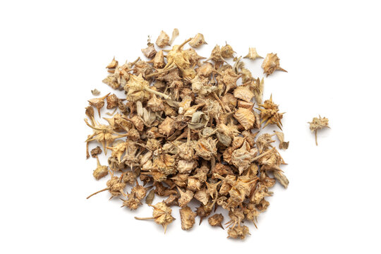 A pile of Dry Organic gokhuru (Tribulus terrestris) fruits, isolated on a white background. Top view
