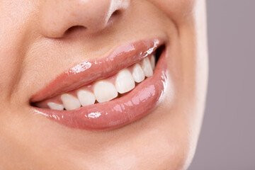 Teeth, dental and woman with smile in studio, health and wellness with oral hygiene on grey background. Orthodontics, fresh breathe and whitening for veneers, happy model with glow and self care