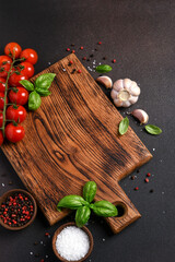 Food background with space for text. Wooden board with vegetables and spices