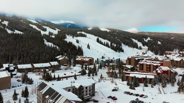 Fog lift cloud layer winter snowy early morning sunrise aerial drone Copper Mountain Colorado ski resort i70 Eagle Flyer lift center village snowboarding half pipe Ikon Epic pass parking lot upward