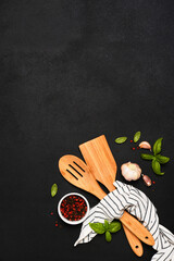 Black Food with kitchen utensils. Kitchen towe andl spatula on a black background. - 752041456