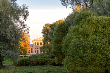Yusupov Palace in St. Petersburg against the background of a blue sky and a crown of a tree with golden leaves