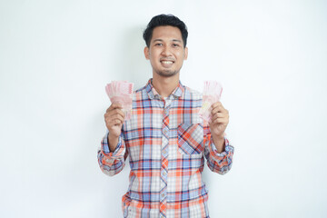 Fototapeta premium Adult Asian man smiling happy at camera while holding money