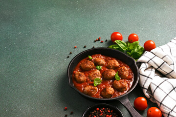 Meatballs with tomato sauce and basil in a frying pan - 752044495