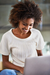 Laptop, smile and adult education with black woman in living room of home for education, learning or study. Computer, video and virtual class with happy young student in apartment for research