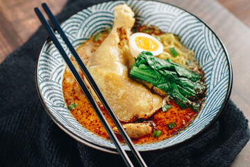 A bowl of soup with noodles and meat in it