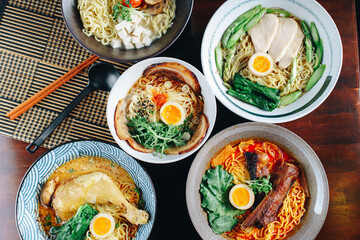A variety of Asian noodle dishes are displayed on a table
