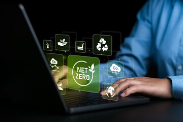 Net zero and carbon neutral concept Business people use computers to analyze net zero, net zero...