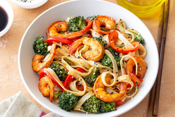Udon noodles with shrimp, broccoli and peppers. Asian cuisine.