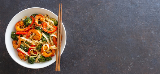 Udon noodles with shrimp, broccoli and peppers. Asian cuisine.