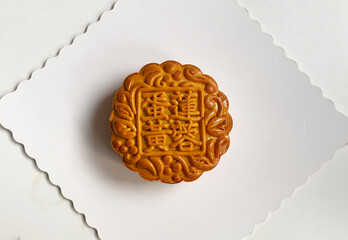 traditional gourmet home made baked moon cake mixed nuts lotus paste egg yolk red bean filling on white background for Chinese mid autumn festival celebration dessert pastry menu halal food in asian