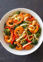 Udon noodles with shrimp, broccoli and peppers. Asian cuisine.