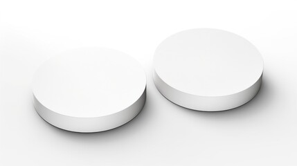 A couple of white round objects on a table. Ideal for product displays