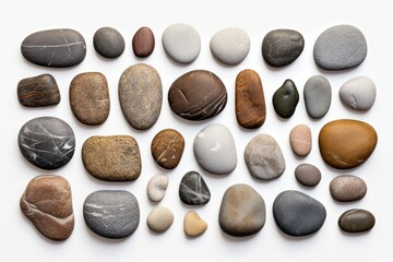 A group of rocks placed on a white surface. Perfect for backgrounds or textures
