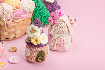 Fototapeta na wymiar Handmade spring decor concept. Creative crocheting, house figurines, traditional flowers and stuff