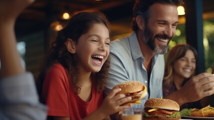 A man and a little girl eating a hamburger. Perfect for family mealtime concepts - obrazy, fototapety, plakaty
