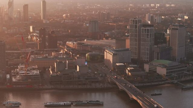 Rising aerial shot of Waterloo bridge and roundabout London at sunrise